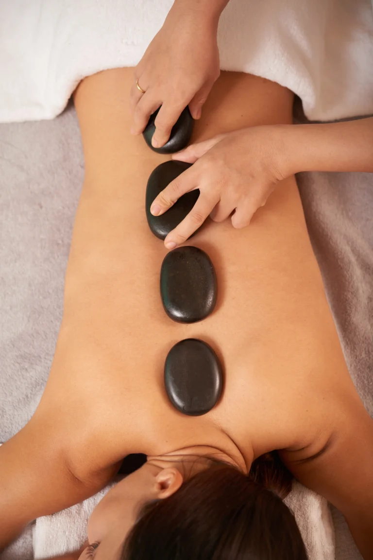 young-woman-having-hot-stone-therapy-massage-spa-salon